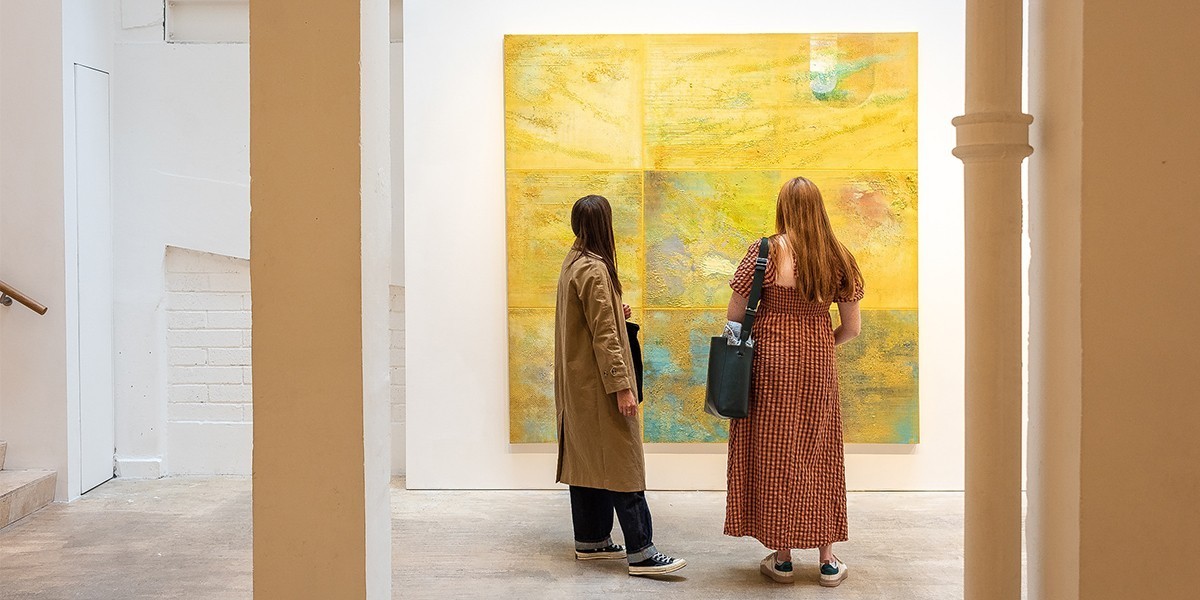 Two women looking at art in an exhibition