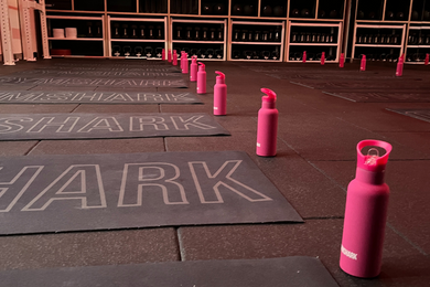 Gymshark workout mats and water bottles arranged on the gym floor