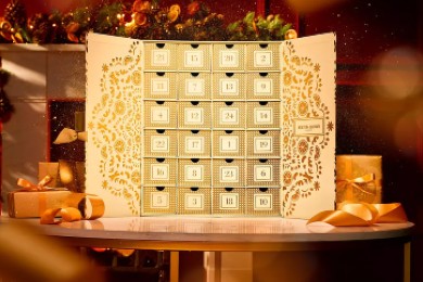 A Molton Brown Advent Calendar sitting atop a decorated table